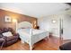 Cozy main bedroom features hardwood floors, a leather recliner, and a large window at 7022 Talbot Dr, Orlando, FL 32819