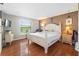 A bright main bedroom with hardwood floors, a large window, and neutral tones at 7022 Talbot Dr, Orlando, FL 32819