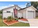 Charming single-Gathering home with a well-manicured front yard, grey trim, and an attached garage at 745 Ashley Ln, Orlando, FL 32825