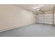 View of the home's clean and spacious two car garage with newly painted walls and epoxy flooring at 745 Ashley Ln, Orlando, FL 32825
