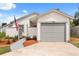 Lovely single-Gathering home with a one car garage and walkway to front door at 745 Ashley Ln, Orlando, FL 32825