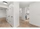 Bright hallway featuring white walls, wood-look floors, and access to the kitchen at 745 Ashley Ln, Orlando, FL 32825