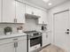 Contemporary kitchen featuring subway tile backsplash, stainless appliances and white cabinetry at 745 Ashley Ln, Orlando, FL 32825