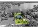 Aerial view of waterfront property with highlighted border on lush, green property at 7801 Georgeann St, Winter Park, FL 32792