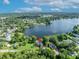 A centered aerial view of the property featuring its proximity to a lake at 7801 Georgeann St, Winter Park, FL 32792