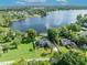 Beautiful aerial view showcasing lakefront home, lush trees, and serene lake at 7801 Georgeann St, Winter Park, FL 32792