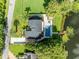 A high aerial view of the house with its yard, waterfront and dock at 7801 Georgeann St, Winter Park, FL 32792
