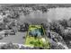 A desaturated aerial view of the property and waterfront at 7801 Georgeann St, Winter Park, FL 32792