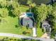 An aerial view of the property showcasing its layout, waterfront and outdoor pool at 7801 Georgeann St, Winter Park, FL 32792