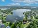 Aerial shot of the property pinpointed to a lake, greenery, and surrounding houses at 7801 Georgeann St, Winter Park, FL 32792