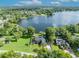 Stunning aerial view of lakefront home with lush landscaping and private dock at 7801 Georgeann St, Winter Park, FL 32792