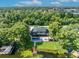 Aerial view of lakefront home with pool, patio, and private dock at 7801 Georgeann St, Winter Park, FL 32792