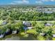 Lakefront backyard featuring a pool, outdoor kitchen, and private boat dock at 7801 Georgeann St, Winter Park, FL 32792