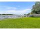 Expansive backyard with lush green grass and tranquil lake views, offering a serene escape at 7801 Georgeann St, Winter Park, FL 32792