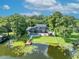 Beautiful backyard with an in-ground pool, patio, and dock at 7801 Georgeann St, Winter Park, FL 32792