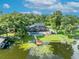 A scenic backyard including a pool, patio, and dock on the water at 7801 Georgeann St, Winter Park, FL 32792