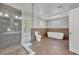 Bright bathroom featuring a glass shower, soaking tub, and stylish tile work with a window for natural light at 7801 Georgeann St, Winter Park, FL 32792