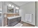 This bathroom boasts a double sink vanity with decorative tile accents and ample lighting at 7801 Georgeann St, Winter Park, FL 32792