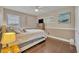 Cozy bedroom with tiled floor, ceiling fan, boat painting, and comfortable neutral-toned furniture at 7801 Georgeann St, Winter Park, FL 32792