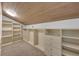 Walk-in closet with custom built-in shelving and storage solutions for efficient organization at 7801 Georgeann St, Winter Park, FL 32792