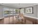 Dining area with sliding glass doors leading to an outdoor space and a waterfront view at 7801 Georgeann St, Winter Park, FL 32792