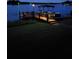Nighttime view of dock area, with a boathouse, lake and boats at 7801 Georgeann St, Winter Park, FL 32792
