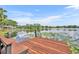 Beautiful wooden dock extending into the lake, featuring lily pads and scenic waterfront views at 7801 Georgeann St, Winter Park, FL 32792