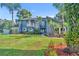 Beautiful two-story home with lush landscaping and a well-manicured lawn at 7801 Georgeann St, Winter Park, FL 32792