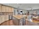 Open kitchen with island, tile backsplash and stainless steel appliances adjacent to the living room at 7801 Georgeann St, Winter Park, FL 32792