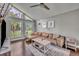 Cozy living room featuring a leather couch, large windows, and ample natural light at 7801 Georgeann St, Winter Park, FL 32792