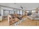 Bright living room with wood floors, open to kitchen, and neutral décor at 7801 Georgeann St, Winter Park, FL 32792