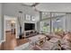 Bright living room with vaulted ceilings, large windows, and comfortable seating at 7801 Georgeann St, Winter Park, FL 32792