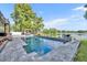 Inviting pool area with a clear view of the lake, complemented by a gazebo and beautifully landscaped surroundings at 7801 Georgeann St, Winter Park, FL 32792