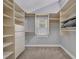 Spacious walk-in closet with custom shelving, drawers, and window, providing ample storage and natural light at 7801 Georgeann St, Winter Park, FL 32792