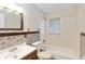 Bathroom featuring a bathtub with shower, decorative tile accents, and a wood vanity at 8111 Esperanza St, Orlando, FL 32817