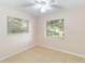 Bright bedroom with tile floor, ceiling fan, and dual windows at 8111 Esperanza St, Orlando, FL 32817