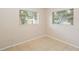 Bedroom showcasing tile floors, neutral paint, and natural light through two windows at 8111 Esperanza St, Orlando, FL 32817