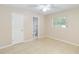 Neutral bedroom featuring tile flooring, a ceiling fan, and a connecting door to the bathroom at 8111 Esperanza St, Orlando, FL 32817