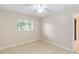 Neutral bedroom featuring tile flooring, a ceiling fan, and a window at 8111 Esperanza St, Orlando, FL 32817
