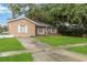 Exterior view showcasing a well-maintained lawn, classic architecture, and inviting curb appeal at 8111 Esperanza St, Orlando, FL 32817