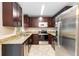 Well-equipped kitchen boasting stainless steel appliances, dark cabinetry, and a functional layout at 8111 Esperanza St, Orlando, FL 32817