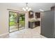 Bright kitchen with stainless steel appliances, tile floor, and sliding glass door to the backyard at 8111 Esperanza St, Orlando, FL 32817