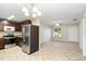 Modern kitchen featuring stainless steel appliances, dark cabinets, and patterned tile flooring, ideal for cooking at 8111 Esperanza St, Orlando, FL 32817