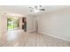 Spacious living area showcasing neutral tones, patterned tile floors, and seamless integration with the kitchen at 8111 Esperanza St, Orlando, FL 32817