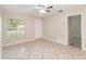 Bright and airy living room featuring neutral walls, patterned tile floors, and ample natural light at 8111 Esperanza St, Orlando, FL 32817