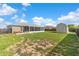 Large grassy backyard features ample space, a screened-in porch, and a handy storage shed at 906 Highland Crest Cir, Lake Wales, FL 33853
