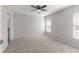 Spacious bedroom with neutral carpet, ceiling fan, and natural light at 906 Highland Crest Cir, Lake Wales, FL 33853