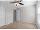 Bright bedroom features a ceiling fan, a window for natural light, and neutral paint at 906 Highland Crest Cir, Lake Wales, FL 33853