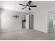 Large bedroom features neutral carpet, ceiling fan, and ensuite bathroom access at 906 Highland Crest Cir, Lake Wales, FL 33853
