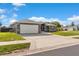 Charming single-story home featuring a gray exterior, well-manicured lawn, and an attached two-car garage at 906 Highland Crest Cir, Lake Wales, FL 33853